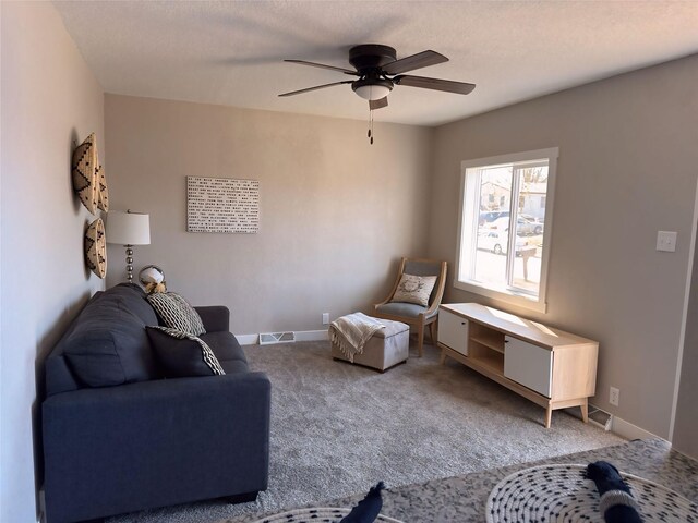 living room featuring visible vents, ceiling fan, carpet flooring, and baseboards