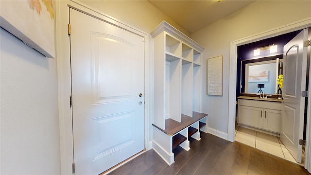 mudroom with dark wood-type flooring and sink