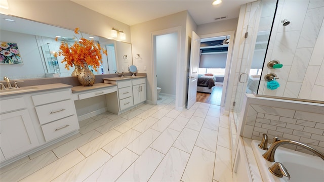 bathroom with vanity, toilet, ceiling fan, and a shower with shower door