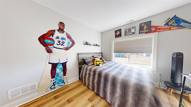 bedroom with hardwood / wood-style flooring