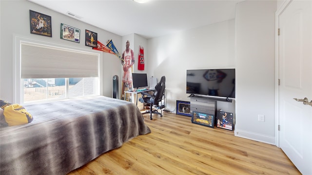 bedroom with hardwood / wood-style floors