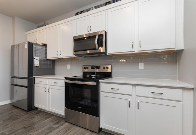 kitchen featuring backsplash, stainless steel appliances, dark hardwood / wood-style floors, and white cabinets