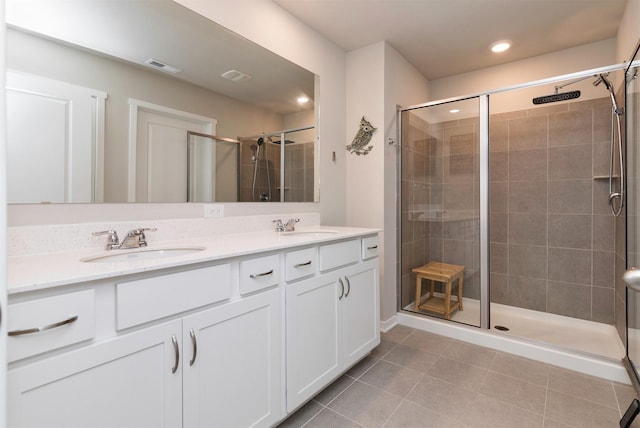 bathroom with walk in shower, tile patterned floors, and vanity