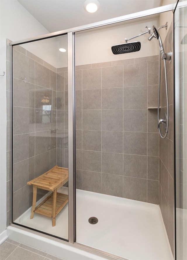 bathroom with tile patterned floors and an enclosed shower