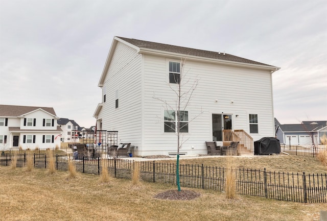 back of property featuring a lawn