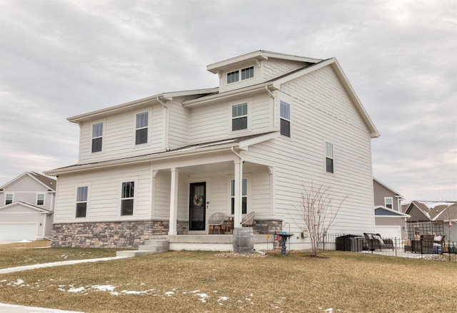 view of front of home featuring a porch, a garage, a front yard, and central air condition unit