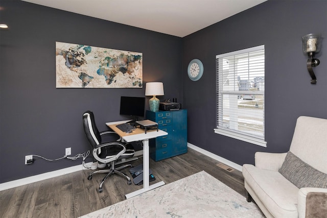 home office with dark hardwood / wood-style flooring