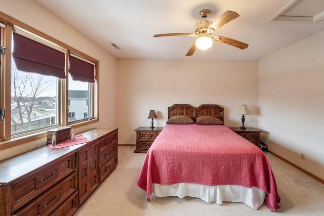 bedroom featuring light colored carpet and ceiling fan