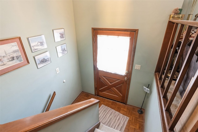 entryway featuring parquet flooring