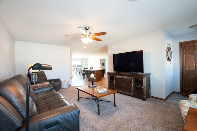 living room with ceiling fan and carpet