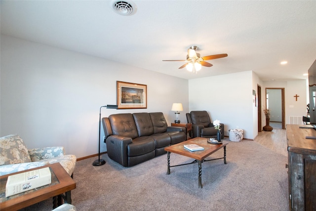 carpeted living room featuring ceiling fan