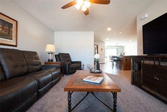 carpeted living room featuring ceiling fan