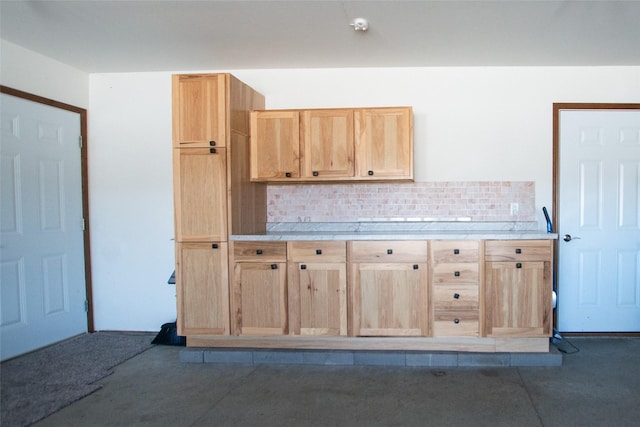 kitchen with light brown cabinets and backsplash