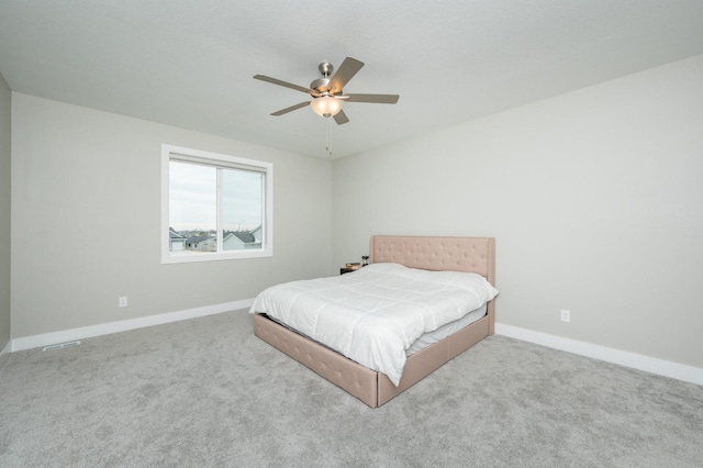 bedroom featuring ceiling fan and light carpet