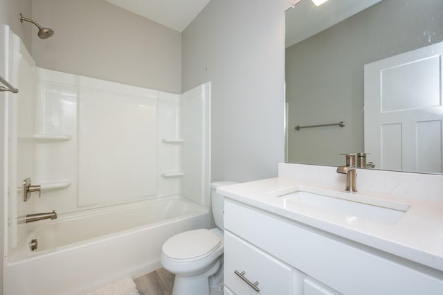 full bathroom with hardwood / wood-style flooring, washtub / shower combination, vanity, and toilet