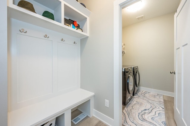 mudroom featuring separate washer and dryer and light wood-type flooring