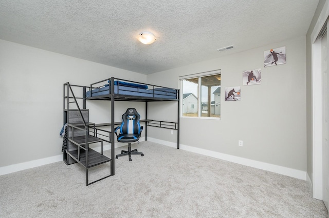 carpeted bedroom with a textured ceiling