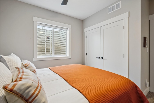 bedroom with ceiling fan and a closet