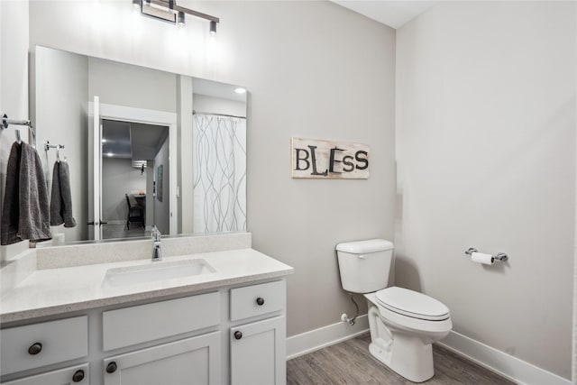 bathroom featuring vanity, toilet, and hardwood / wood-style floors