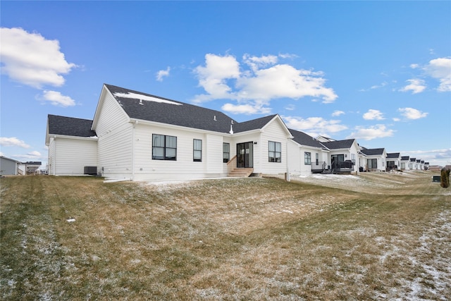 rear view of house with a yard, a patio area, and central air condition unit