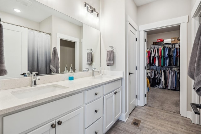 bathroom with vanity and hardwood / wood-style floors