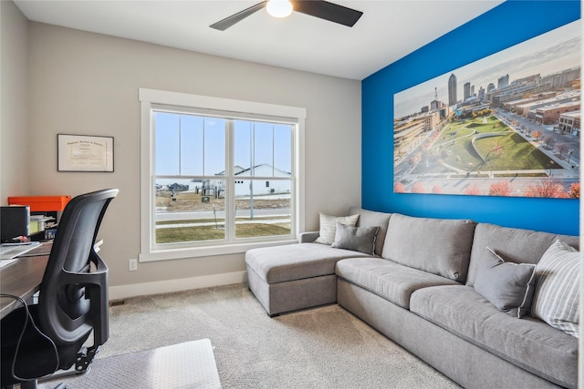 carpeted office featuring ceiling fan