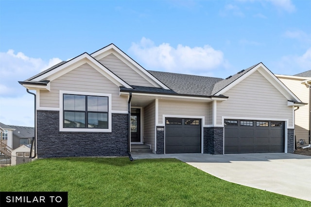 craftsman inspired home featuring a garage and a front lawn