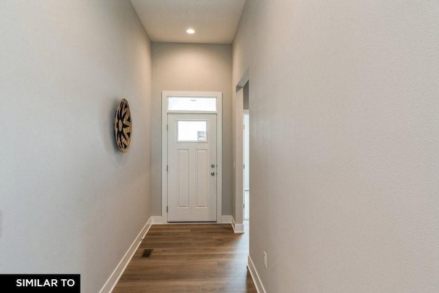 doorway to outside with dark wood-type flooring