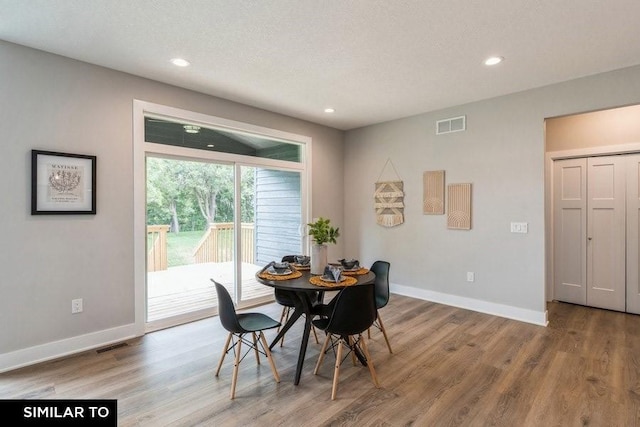 dining room with wood-type flooring