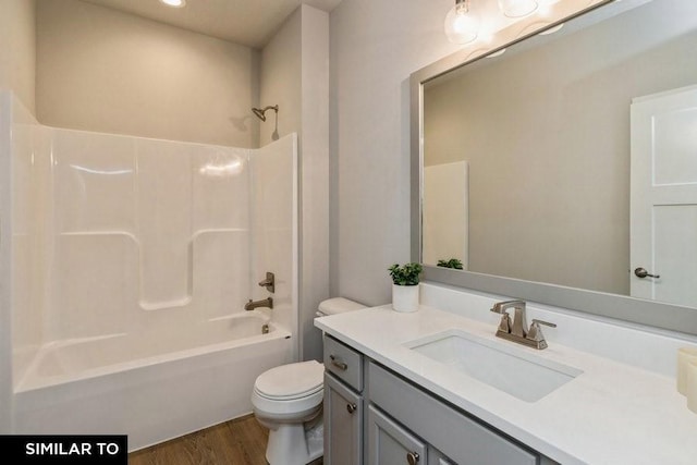 full bathroom with shower / bathtub combination, wood-type flooring, toilet, and vanity