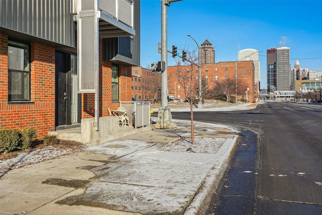 400 SW 7th St Unit 105, Des Moines, IA 50309 - view of asphalt road with curbs, sidewalks, a city view, street lights, and traffic lights