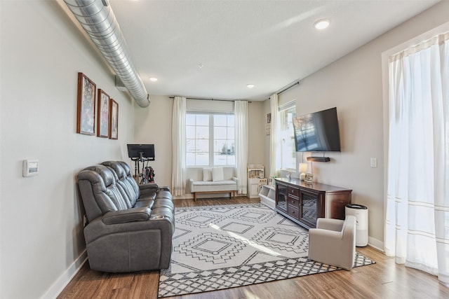 400 SW 7th St Unit 105, Des Moines, IA 50309 - living room featuring wood finished floors, baseboards, and recessed lighting