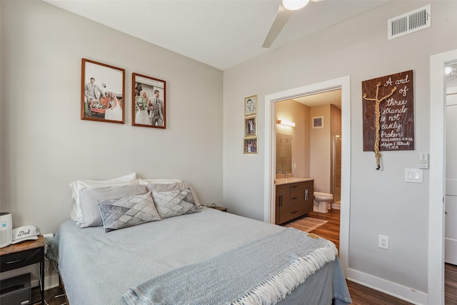 bedroom with dark hardwood / wood-style floors, ceiling fan, and connected bathroom