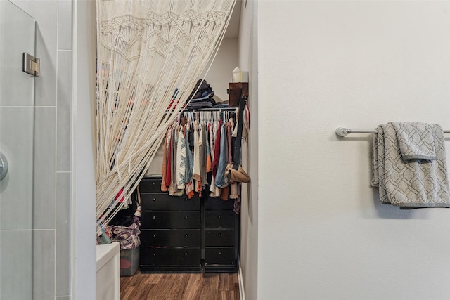 walk in closet featuring dark wood-type flooring