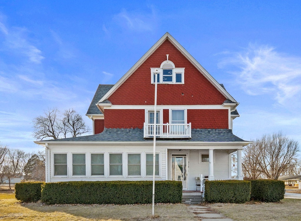 rear view of house featuring a porch