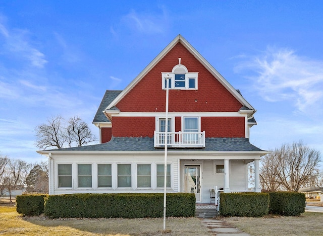 rear view of house featuring a porch