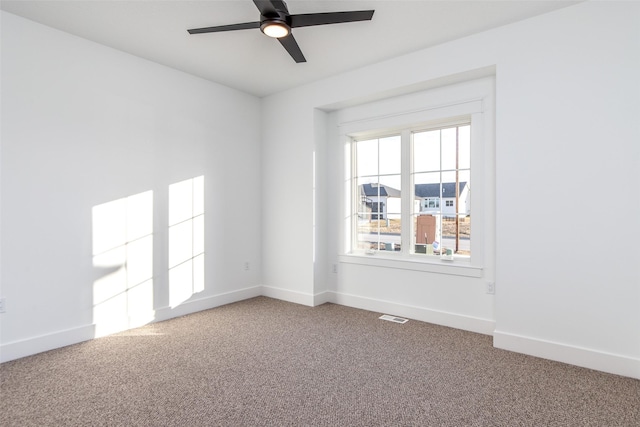 spare room featuring ceiling fan and carpet flooring