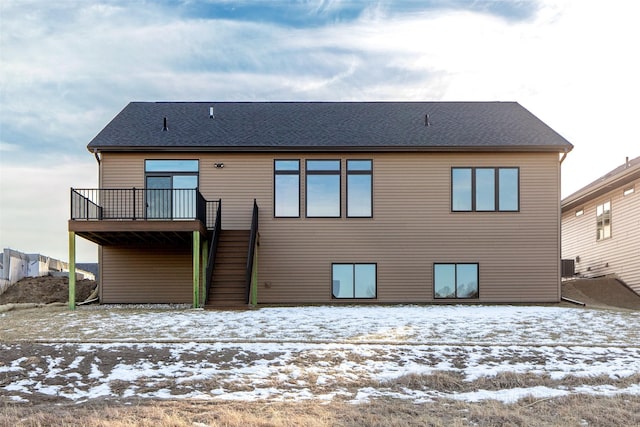 snow covered property featuring central AC