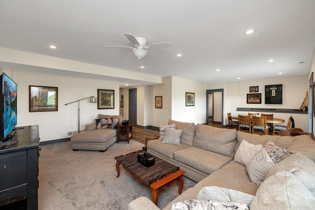 living room featuring ceiling fan and carpet flooring