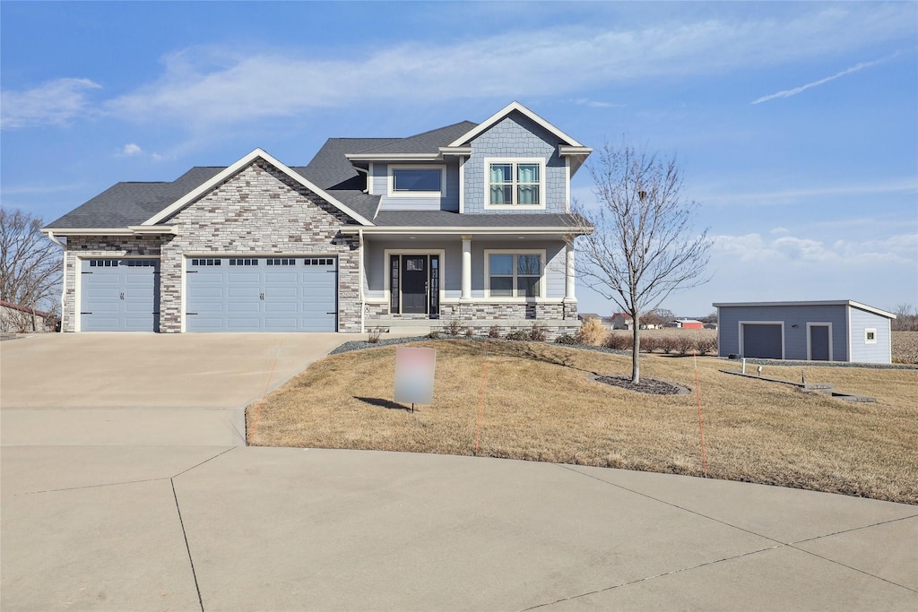 craftsman house with a garage, a front lawn, and a porch