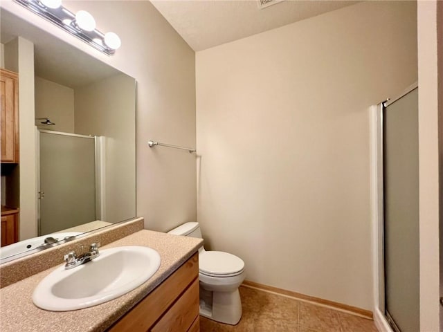 bathroom with vanity, tile patterned flooring, a shower with door, and toilet