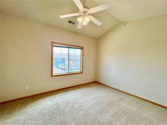 spare room with ceiling fan, carpet flooring, and vaulted ceiling