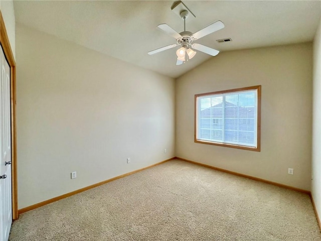 carpeted empty room featuring lofted ceiling and ceiling fan