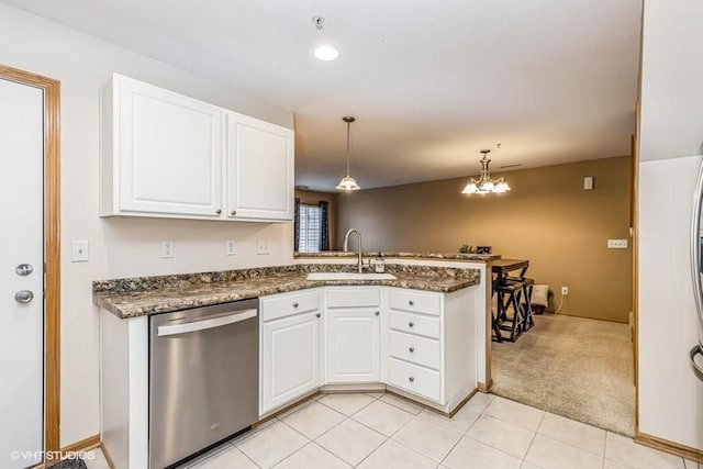 kitchen featuring dishwasher, sink, kitchen peninsula, and white cabinets