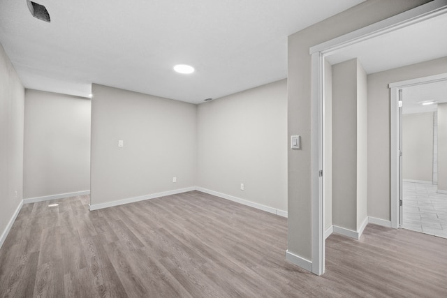 basement with light hardwood / wood-style flooring