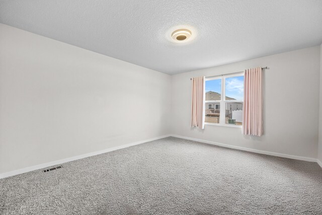 10431 Southerwick Pl, Johnston, IA 50131 - carpeted empty room with a textured ceiling, baseboards, and visible vents