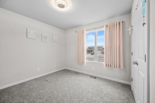 10431 Southerwick Pl, Johnston, IA 50131 - empty room featuring carpet, baseboards, a textured ceiling, and visible vents