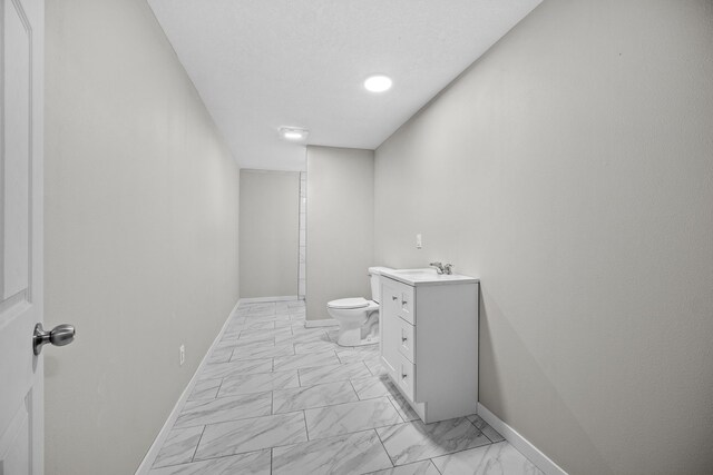 10431 Southerwick Pl, Johnston, IA 50131 - bathroom with baseboards, marble finish floor, toilet, and vanity