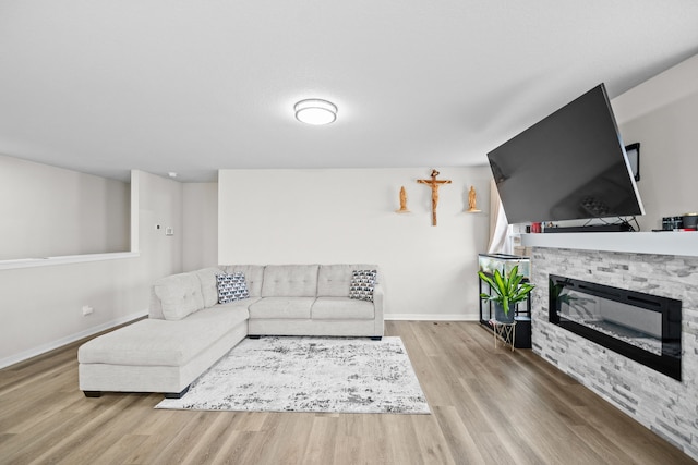 living room with light wood-type flooring and a fireplace