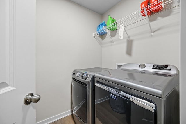 laundry area featuring hardwood / wood-style flooring and washer and clothes dryer